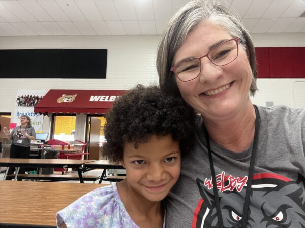 Welby elementary student and adult.